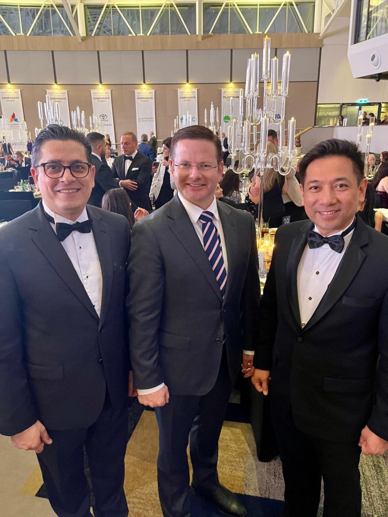 Nathan Tal with guests at a formal community event